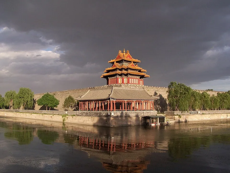 The Forbidden City’s northwest corner tower reflected in its moat at sunset
